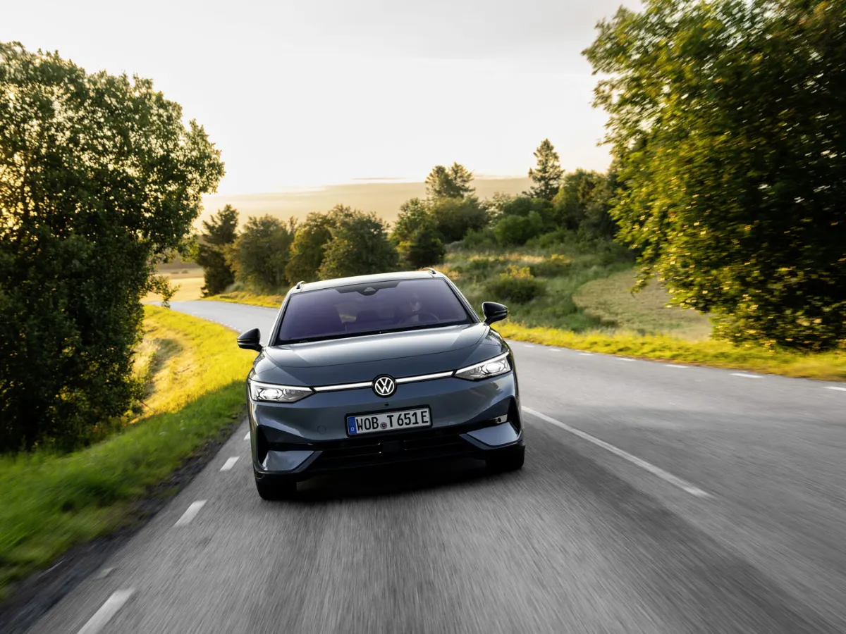 Volkswagen ID.7 Tourer front view, among trees